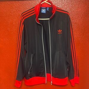 Brand: Adidas Size: L
Color: black and red ( 3 stripes)- within the 3 stripes